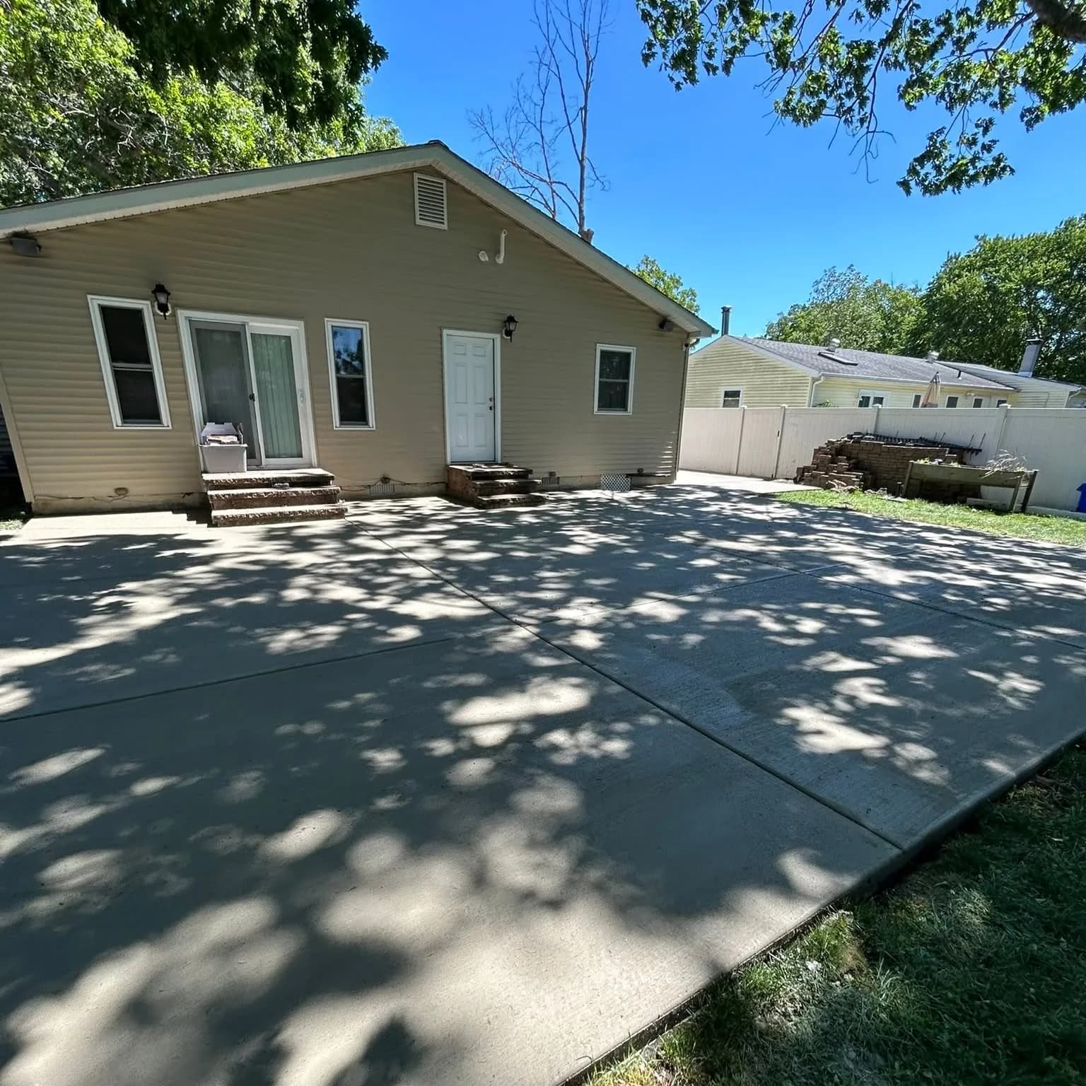 New poured concrete patio in a South Jersey backyard by D&R Services